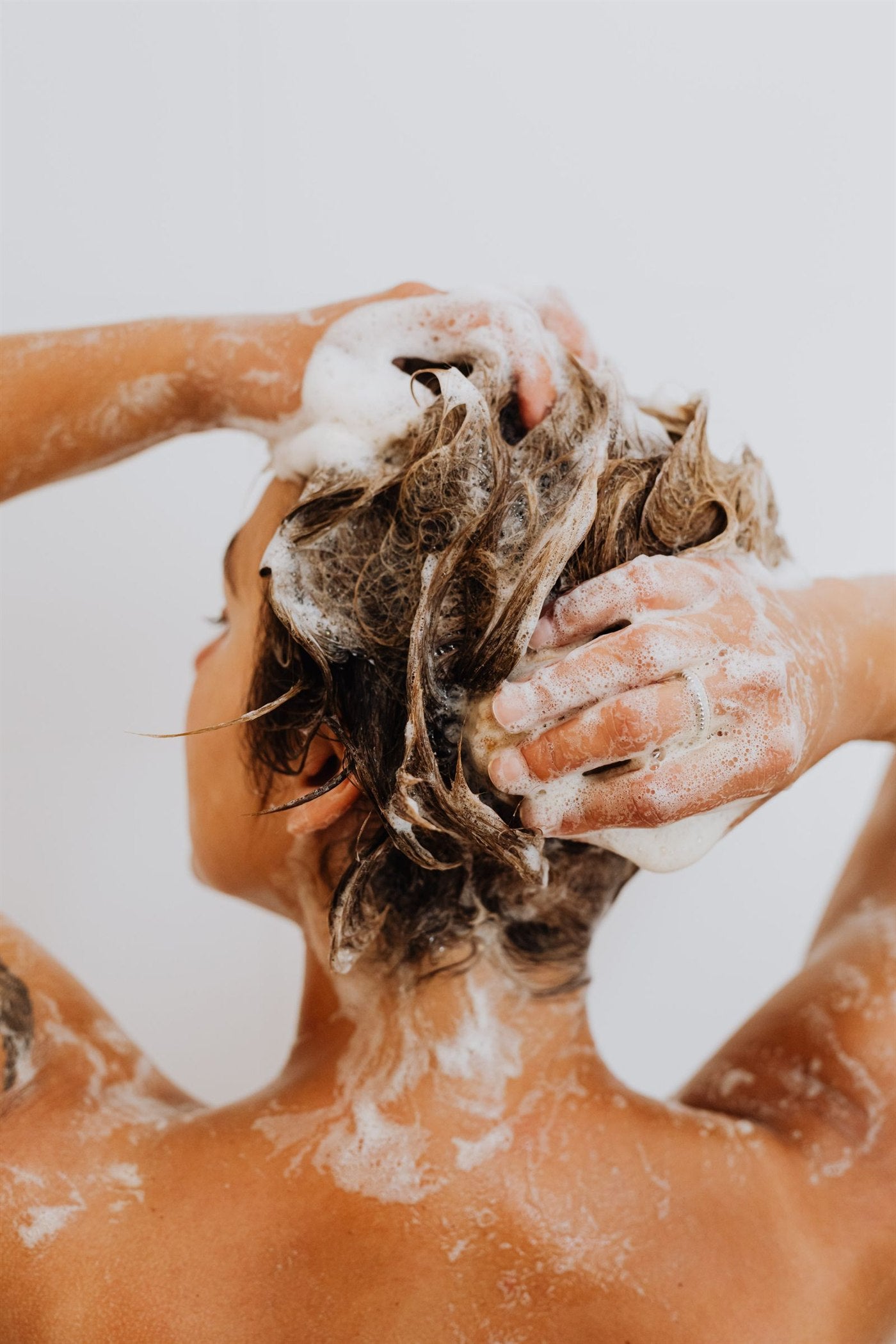 Residue, impurities, visible flakes, or loosened buildup can leave scalp and hair feeling less clean.